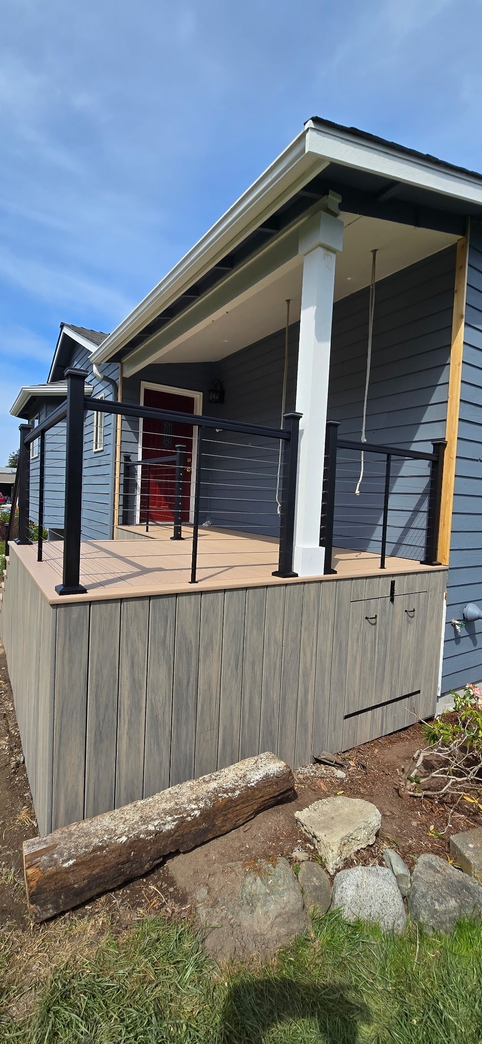 Covered composite front porch with cable railing