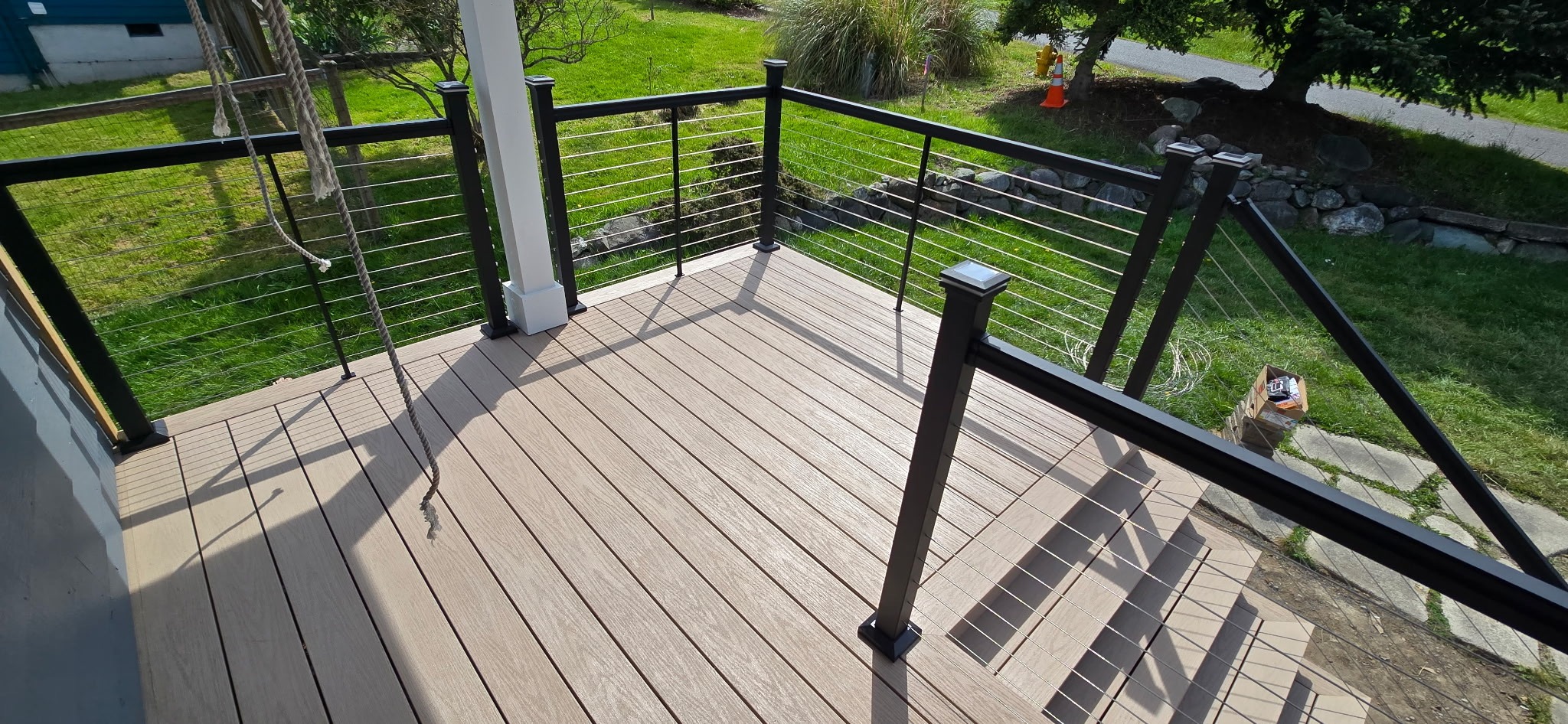 Corner section of composite porch with cable railing