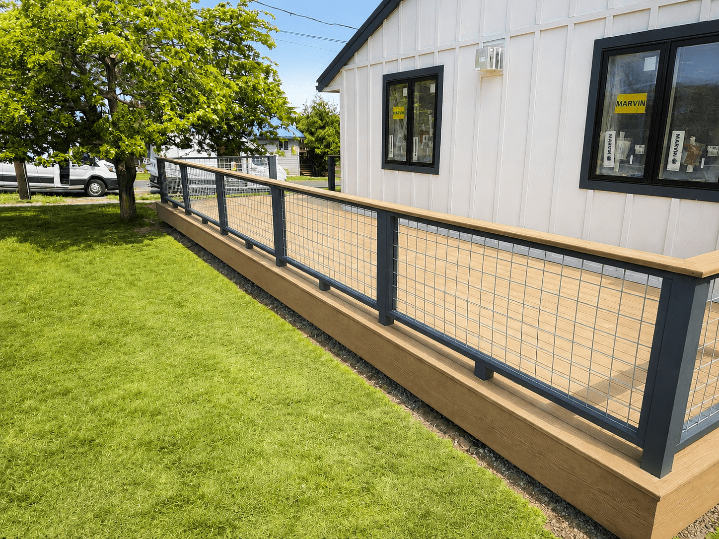 Custom composite deck featuring modern powder-coated railing and premium outdoor living space in Coupeville, Washington.