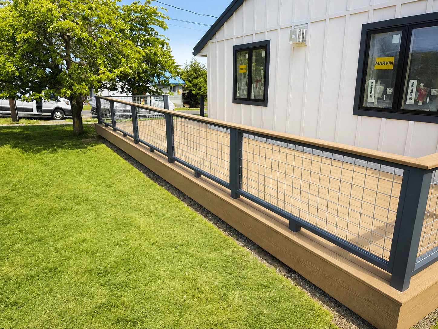 Custom composite deck featuring modern powder-coated railing and premium outdoor living space in Coupeville, Washington.