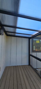 Translucent covered deck roof panels and black framing in Coupeville, WA