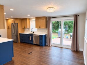 Prestige kitchen remodel with Valhalla Blue lower cabinetry, white countertops, and natural wood upper cabinets in Burlington