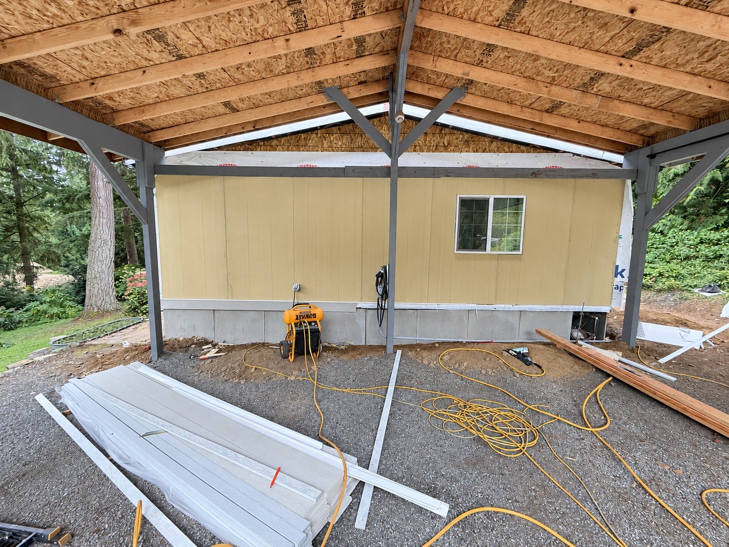 Covered structure framing and exterior renovation by Prestige Home Services, photographed October 2026